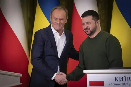 Poland's Prime Minister Donald Tusk, left, and Ukrainian President Volodymyr Zelenskyy shake hands during their meeting in Kyiv, Ukraine, Monday, Jan. 22, 2024. (Ukrainian Presidential Press Office via AP)
