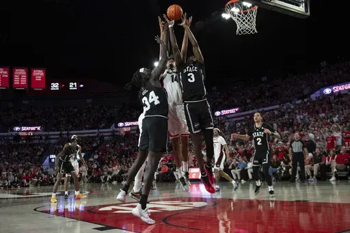Georgia forward Asa Newell (14), Mississippi State forward KeShawn Murphy (3), Mississippi State center Gai Chol (34) and Georgia center Somto Cyril (6) reach to rebound the ball during the first half of an NCAA college basketball game, Saturday, Feb. 8, 2025, in Athens, Ga. (AP Photo/Kathryn Skeean)