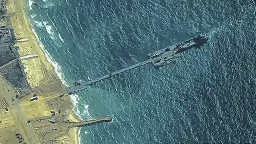 The image provided by U.S, Central Command, shows U.S. Army soldiers assigned to the 7th Transportation Brigade (Expeditionary), U.S. Navy sailors assigned to Amphibious Construction Battalion 1, and Israel Defense Forces placing the Trident Pier on the coast of Gaza Strip on Thursday, May 16, 2024. The temporary pier is part of the Joint Logistics Over-the-Shore capability. The U.S. military finished installing the floating pier on Thursday, with officials poised to begin ferrying badly needed 