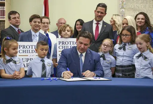 Florida Gov. Ron DeSantis signs the Parental Rights in Education bill at Classical Preparatory school on March 28, 2022, in Shady Hills, Fla. The Florida Board of Education on Wednesday, April 19, 2023, approved a ban on classroom instruction about sexual orientation and gender identity in all grades, expanding the law critics call “Don't Say Gay” at the request of Gov. DeSantis as he gears up for an expected presidential run. (Douglas R. Clifford/Tampa Bay Times via AP, File)