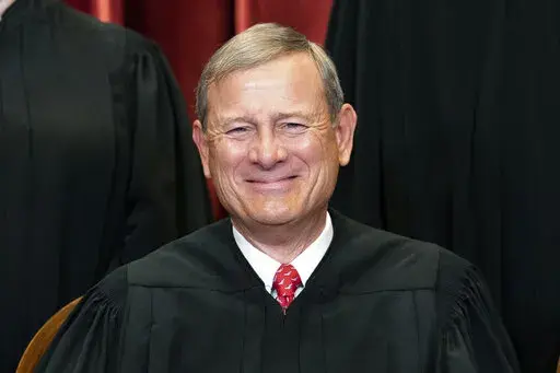 Chief Justice John Roberts sits during a group photo at the Supreme Court in Washington, April 23, 2021. Roberts is set to make his first public appearance since the U.S. Supreme Court overturned Roe v. Wade, speaking Friday night, Sept. 9, 2022, at a judicial conference in Colorado.(Erin Schaff/The New York Times via AP, Pool, File)