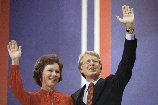 Jimmy Carter, right, and his wife, Rosalynn Carter, wave together at the National Convention in Madison Square Garden, July 15, 1976, in New York. Rosalynn Carter, the closest adviser to Jimmy Carter during his one term as U.S. president and their four decades thereafter as global humanitarians, died Sunday, Nov. 19, 2023. She was 96. (AP Photo, File)