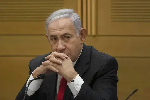 Former Israeli Prime Minister Benjamin Netanyahu speaks to right-wing opposition party members, at the Knesset, Israel's parliament, in Jerusalem on June 14, 2021. Former Israeli Prime Minister Benjamin Netanyahu is negotiating a plea deal in his corruption case. A person involved in the negotiations said Sunday, Jan. 16, 2021, that the agreement is likely to be announced in the coming days and could usher Netanyahu off the Israeli political stage for years. (AP Photo/Maya Alleruzzo, File)