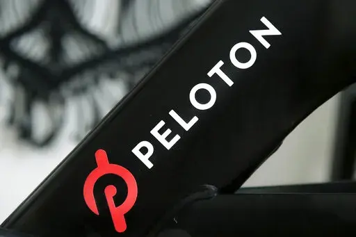 A Peloton logo is seen on the company's stationary bicycle on Nov. 19, 2019, in San Francisco. In a statement  on Wednesday, Aug. 24, 2022, Peloton announced that their high-end exercise bikes and other gear will now be available for purchase on Amazon in the U.S., a partnership aimed at boosting the fitness company's sales that have languished since the easing of pandemic lockdowns. (AP Photo/Jeff Chiu, File)