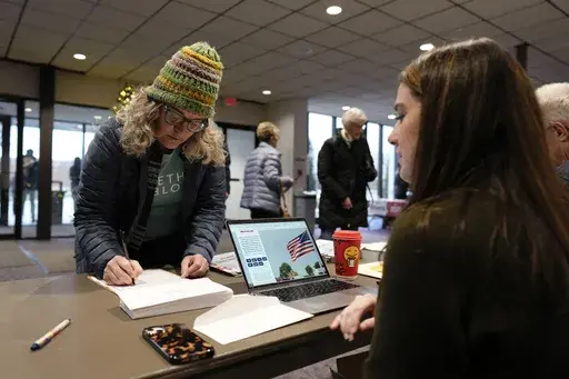 An audience member arrives at U.S. Rep. Randy Feenstra's, R-Iowa, Faith and Family with the Feenstras event, Saturday, Dec. 9, 2023, in Sioux Center, Iowa. (AP Photo/Charlie Neibergall)
