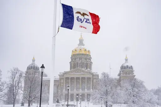 Snow falls at the Iowa State Capitol Building in Des Moines, Iowa, Jan. 9, 2024, as a winter snow storm hits the state. As frigid temperatures scour the Midwest, Monday, Jan. 15, marks the official start to the Republican presidential nominating contest with the Iowa caucuses. Iowa has been relatively quiet this cycle compared to years past, because former President Donald Trump is dominating the contest. That makes one of the things to watch Monday who comes in second. (AP Photo/Andrew Harnik, 