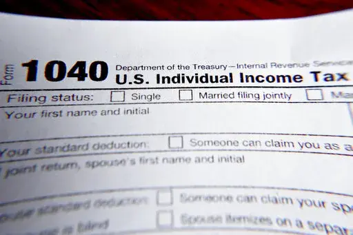 This Wednesday, Feb. 13, 2019 file photo shows part of a 1040 federal tax form printed from the Internal Revenue Service website, in Zelienople, Pa. Small-business owners, freelancers and people with side gigs can reduce their tax bills and their anxiety levels this tax-filing season by knowing the taxability rules for Paycheck Protection Program money, taking advantage of new deductions for business meals and mileage and putting money in tax-advantaged retirement accounts designed for self-empl