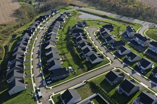 Homes in Middlesex Township, Pa., are shown on Apr. 19, 2023. A case in federal court in Missouri ended Tuesday with a jury ordering the National Association of Realtors and some of the nation's biggest real estate brokerages to pay almost $1.8 billion in damages after finding that they artificially inflated commissions paid to real estate agents. (AP Photo/Gene J. Puskar, File)