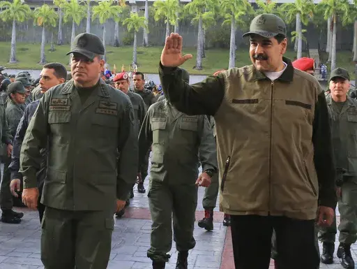 In this May 2, 2019 photo released by the Miraflores Press Office, Venezuela's President Nicolas Maduro, right, accompanied by his Defense Minister Vladimir Padrino, waves upon his arrival to Fort Tiuna, in Caracas, Venezuela. Venezuelan military officials said Saturday, Dec. 30, 2023, that they will continue to deploy nearly 6,000 troops until a British military vessel sent to neighboring Guyana leaves the waters off the coast of the two South American nations. (Jhonn Zerpa/Miraflores Press Off