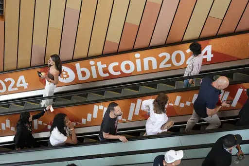 People arrive at the Bitcoin 2024 Conference on July 24, 2024, in Nashville, Tenn. (AP Photo/Mark Humphrey, File)