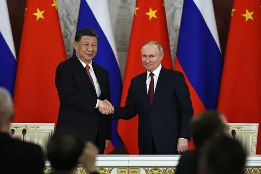 Russian President Vladimir Putin, right, and Chinese President Xi Jinping shake hands after speaking to the media during a signing ceremony following their talks at The Grand Kremlin Palace, in Moscow, Russia, March 21, 2023. China’s leader Xi just concluded his three-day visit with Russian President Vladimir Putin, a warm affair in which the two men praised each other and spoke of a profound friendship. It’s a high in a complicated, centuries-long relationship in which the two countries hav