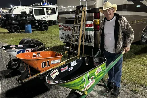 Cush Revette shows off his wheelbarrow collection he uses for the annual races at Daytona International Speedway, Wednesday, Feb 12 in Daytona Beach, Fla. { AP Photo/ Mark Long)