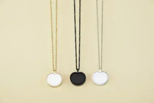 This image provided by Bond-Touch shows the Bond Heart smart necklace, which stores and plays heartbeats with the help of an app. Think outside the box for Mother's Day gifts this year. (Bond-Touch via AP).