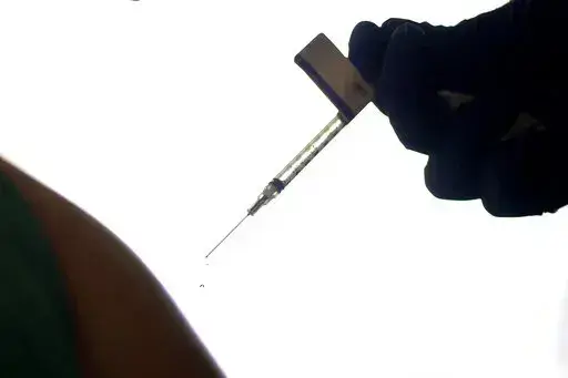 A droplet falls from a syringe after a health care worker was injected with the Pfizer-BioNTech COVID-19 vaccine at Women & Infants Hospital in Providence, R.I., on Dec. 15, 2020. On Friday, June 10, 2022, The Associated Press reported on stories circulating online incorrectly claiming that 20,000 people have died from COVID-19 vaccines. The figure misrepresents data maintained by the Centers for Disease Control and Prevention and the Food and Drug Administration. To date, a total of nine deaths