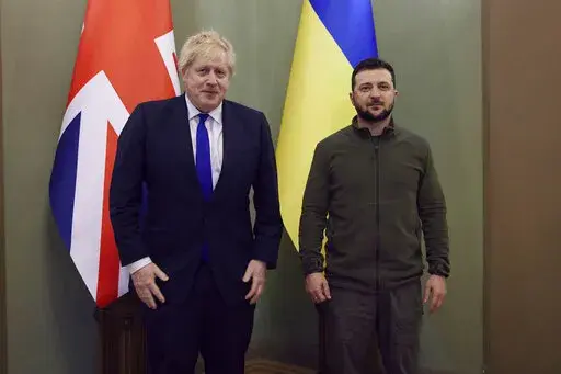 In this image provided by the Ukrainian Presidential Press Office, Britain's Prime Minister Boris Johnson, left and Ukrainian President Volodymyr Zelenskyy pose for a photo, in Kyiv, Ukraine, Saturday, April 9, 2022.  Johnson has traveled to Ukraine to meet with President Volodymyr Zelenskyy in show of solidarity. The two leaders meeting Saturday discussed the “U.K.’s long term support to Ukraine’’ including a new package of financial and military aid, the prime minister’s office said.