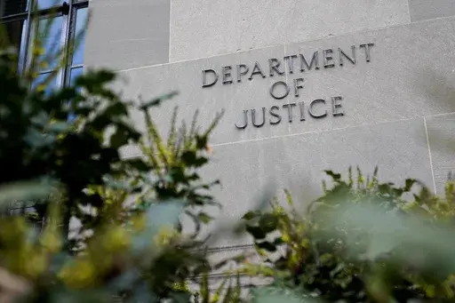 A sign marks an entrance to the Robert F. Kennedy Department of Justice Building in Washington, Jan. 23, 2023. The Justice Department proposed changes Monday, Feb. 5, 2024, to rules governing state-run programs that provide financial assistance to violent crime victims in order to address racial disparities and curb the number of subjective denials of compensation. (AP Photo/Patrick Semansky, File)