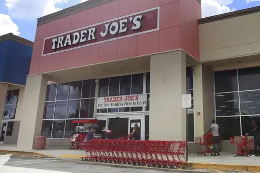 People stand in line waiting to enter Trader Joe's to buy groceries in Pembroke Pines, Fla., on March 24, 2020. More than 61,000 pounds of steamed chicken soup dumplings sold at Trader Joe's are being recalled for possibly containing hard plastic, U.S. regulators announced Saturday, March 2, 2024. (AP Photo/Brynn Anderson, File)