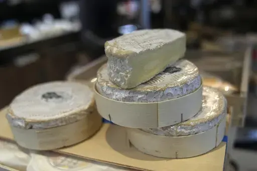 Camembert cheeses in their box are on sale in a Ville d'Avray cheese shop, outside Paris, Tuesday, Nov. 21, 2023. In one of the many legal proposals on streamlining and optimizing waste management throughout the 27-nation bloc, some French cheese producers sniffed out something and turned it into a culinary stink. They claimed that the proposal would make it illegal for Camembert to be cradled into the wooden packaging for its final weeks of ripening and, eventually, sale. The round box is as es