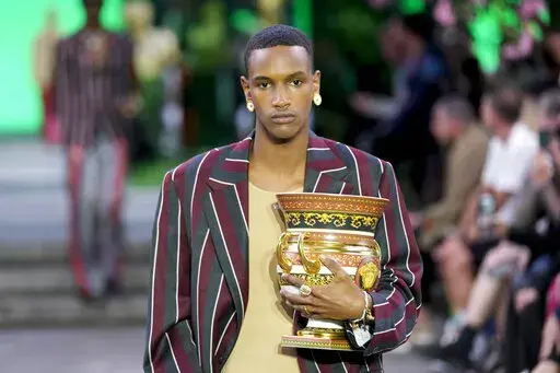 A model wears a creation as part of the Versace men's Spring Summer 2023 collection presented in Milan, Italy, Saturday, June 18, 2022. (AP Photo/Luca Bruno)