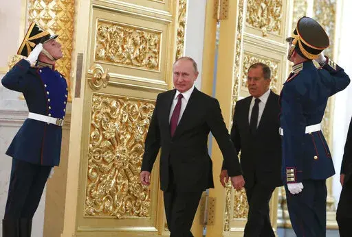 Russian President Vladimir Putin and Foreign Minister Sergei Lavrov walk past honour guards as they attend a ceremony to receive diplomatic credentials from newly appointed foreign ambassadors at the Kremlin in Moscow, Russia, Thursday, Oct. 11, 2018. In the wake of the 2022 invasion of Ukraine, U.S. sanctions are targeting Putin and a handful of individuals believed to be among his closest security advisers, including Lavrov. (Sergei Karpukhin/Pool Photo via AP, File)