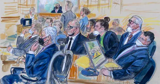 This artist sketch depicts the trial of Oath Keepers leader Stewart Rhodes and four others charged with seditious conspiracy in the Jan. 6, 2021, Capitol attack, in Washington, Thursday, Oct. 6, 2022. Shown above are, witness John Zimmerman, who was part of the Oath Keepers’ North Carolina Chapter, seated in the witness stand, defendant Thomas Caldwell, of Berryville, Va., seated front row left, Oath Keepers leader Stewart Rhodes, seated second left with an eye patch, defendant Jessica Watkins