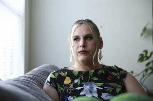 Sage Chelf poses for a photo at her home in Orlando, Fla., May 27, 2023. Recent Florida legislation has caused Chelf, a trans woman, to lose access to her hormone replacement therapy. She's hoping to move to Illinois in the coming weeks to stay with her girlfriend and regain access to care. (AP Photo/Laura Bargfeld)