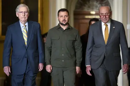 Ukrainian President Volodymyr Zelenskyy, center, walks with Senate Minority Leader Mitch McConnell of Ky., left, and Senate Majority Leader Chuck Schumer of N.Y., right, at Capitol Hill on Thursday, Sept. 21, 2023, in Washington. (AP Photo/Mark Schiefelbein, File)
