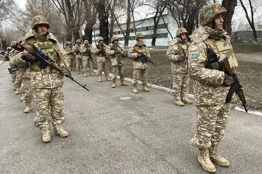 In this photo released by the Russian Defense Ministry Press Service, Collective Security Treaty Organization peacekeepers prepare to guard an area in Almaty, Kazakhstan, Tuesday, Jan. 11, 2022. The president of Kazakhstan has announced that a Russia-led security alliance will start pulling out its troops from the Central Asian country in two days after completing its mission. The mostly Russian troops were deployed to Kazakhstan last week by the Collective Security Treaty Organization, an allia