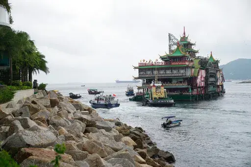Hong Kong's iconic Jumbo Floating Restaurant is towed away in Hong Kong on June 14, 2022. The restaurant has capsized in the South China Sea less than a week after it was towed away from the city, its parent company said Monday, June 20, 2022. (AP Photo/Kin Cheung, File)