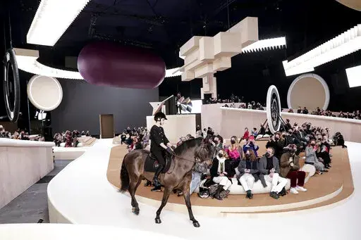 Charlotte Casiraghi rides a horse as she wears a creation for the Chanel Spring-Summer 2022 Haute Couture fashion collection collection, in Paris, Tuesday, Jan. 25, 2022. (AP Photo/Lewis Joly)