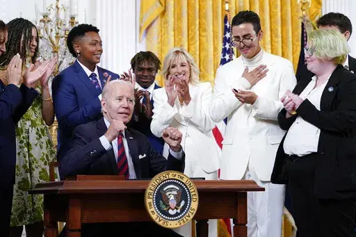 President Joe Biden celebrates after signing an executive order at an event to celebrate Pride Month in the East Room of the White House, Wednesday, June 15, 2022, in Washington. (AP Photo/Patrick Semansky)