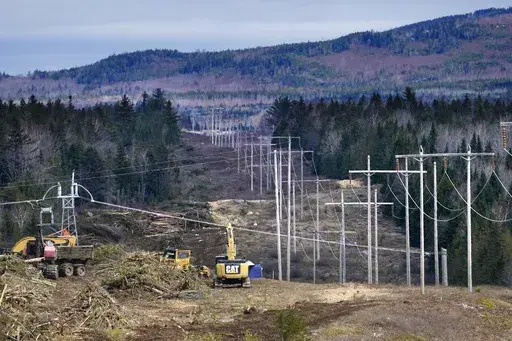 Heavy machinery is used to cut trees to widen an existing Central Maine Power power line corridor to make way for new utility poles, April 26, 2021, near Bingham, Maine. Stalled spending on electrical grids worldwide is slowing the rollout of renewable energy and could put efforts to limit climate change at risk if millions of miles of power lines aren't added or refurbished in the next few years. The International Energy Agency said in a report Tuesday that the capacity to connect to and transm
