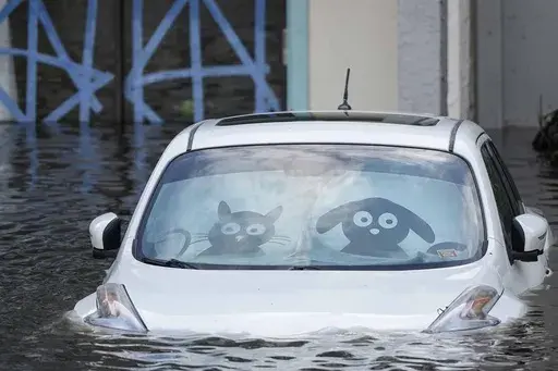 A car is submerged in flood water at an apartment complex in the aftermath of Hurricane Milton, Thursday, Oct. 10, 2024, in Clearwater, Fla. (AP Photo/Mike Stewart)