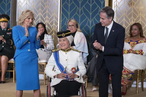 Malaysian Senator Datuk Ras Adiba Radzi receives the International Women of Courage Award from Secretary of State Antony Blinken with first lady Jill Biden, during a ceremony in the East Room of the White House, in Washington, to commemorate International Women's Day, Wednesday, March 8, 2023. (AP Photo/Manuel Balce Ceneta)
