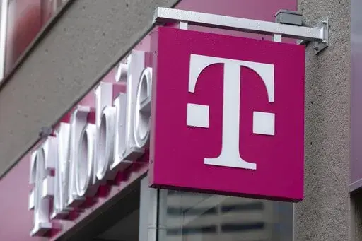 The T-Mobile logo is seen on a storefront, Oct. 14, 2022, in Boston. The U.S. wireless carrier T-Mobile said Thursday, Jan. 19, 2023, that an unidentified malicious intruder breached its network in late November and stole data on 37 million customers, including addresses, phone numbers and dates of birth. (AP Photo/Michael Dwyer, File)