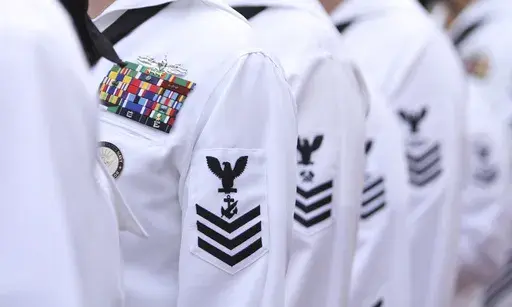 Enlisted sailors line up and wait to march on the field at Sun Life Stadium before the NFL football game in Miami, Nov. 13, 2011, between the Washington Redskins and Miami Dolphins. The Navy will begin randomly testing its special operations forces for steroids and other performance-enhancing drugs beginning in November, taking a groundbreaking step that military leaders have long resisted. Rear Adm. Keith Davids, commander of Naval Special Warfare Command, announced the new program Friday, Sept