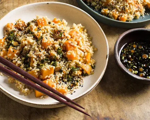 This image released by Milk Street shows a recipe for sweet potato brown rice with soy and scallions. (Milk Street via AP)