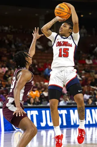 Mississippi's Angel Baker (15) goes up for a shot against Texas A&M's McKinzie Green (23) in the first half of an NCAA college basketball game during the Southeastern Conference women's tournament in Greenville, S.C., Friday, March 3, 2023. (AP Photo/Mic Smith)