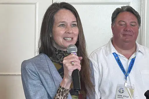 Jen Easterly, Director of Department of Homeland Security's Cybersecurity and Infrastructure Security Agency, speaks during the summer conference of the National Association of Secretaries of State on July 7, 2022, in Baton Rouge, La., as Kyle Ardoin, Louisiana Secretary of State listens. Election officials have a long list of challenges as they prepare for the upcoming midterms. They face a myriad of threats, both foreign and domestic, as they work to protect voting systems and run a smooth ele