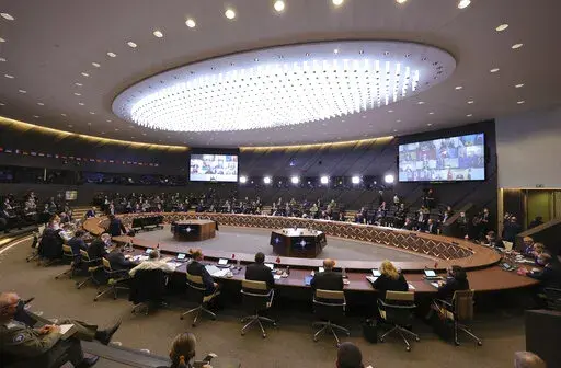 NATO Secretary General Jens Stoltenberg, center left, convenes NATO leaders, both in person and on screen, for a virtual summit at NATO headquarters in Brussels, Friday, Feb. 25, 2022. The day after Russia invaded Ukraine, the leaders of NATO’s 30 member countries convened an emergency virtual summit to address what they described as the gravest threat to Euro-Atlantic security in decades – the launch of what would become the biggest land war in Europe since 1945. (AP Photo/Olivier Matthys)