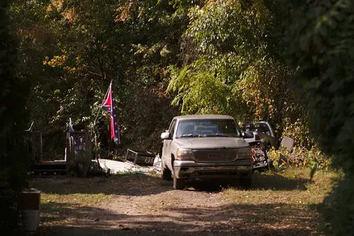 A confederate flag hangs from a porch on a property in Munith, Mich., Oct. 9, 2020, where law enforcement officials said suspects accused in a plot to kidnap Michigan Democratic Gov. Gretchen Whitmer met to train and make plans. Four members of anti-government groups are on trial on federal charges accusing them of plotting to abduct Whitmer in 2020. (Nicole Hester/Ann Arbor News via AP, File)