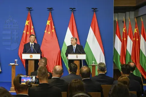 Chinese President Xi Jinping, left, listens during his joint press conference with Hungarian Prime Minister Viktor Orban following their talks at the PM's office, the former Carmelite Monastery, in Budapest, Hungary, Thursday, May 9 2024. Most countries in the European Union are making efforts to “de-risk” their economies from perceived threats posed by China. But Hungary and Serbia have gone in the other direction. They are courting major Chinese investments in the belief that the world’s