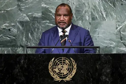 CORRECTS TO DELETE THE DEATH TOLL AS THE NUMBER HAS LOWERED AFTER MORE REPORT - FILE - Prime Minister of Papua New Guinea James Marape addresses the 77th session of the United Nations General Assembly, Sept. 22, 2022, at U.N. headquarters. Multiple people were massacred in a major escalation of tribal violence in Papua New Guinea, Australian media reported Monday, Feb. 19, 2024. Tribal violence in the Enga region has intensified since elections in 2022 that maintained Prime Minister James Marape