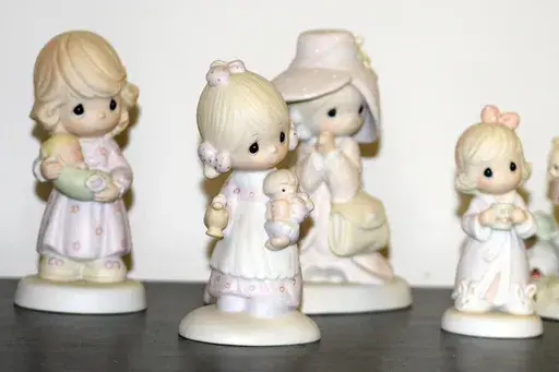 A selection of Precious Moments figurines sit on a shelf, Thursday, May 23, 2024, in Blaine, Minn. Sam Butcher, the artist who created the Precious Moments figurines depicting angelic teardrop-eyed children, died early Monday, May 20, 2024, surrounded by family. He was 85. (Lissa Forliti-Aska via AP)