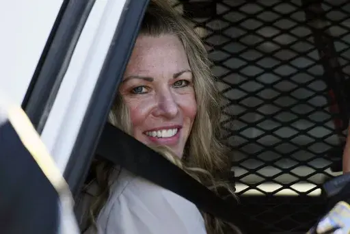 Lori Vallow Daybell sits in a police car after a hearing at the Fremont County Courthouse in St. Anthony, Idaho, on Aug. 16, 2022. The sister of Tammy Daybell, who was killed in what prosecutors say was a doomsday-focused plot, told jurors Friday, April 28, 2023, that her sister's funeral was held so quickly that some family members couldn't attend. The testimony came in the triple murder trial of Vallow Daybell, who is accused along with Chad Daybell in Tammy's death and the deaths of Vallow Da