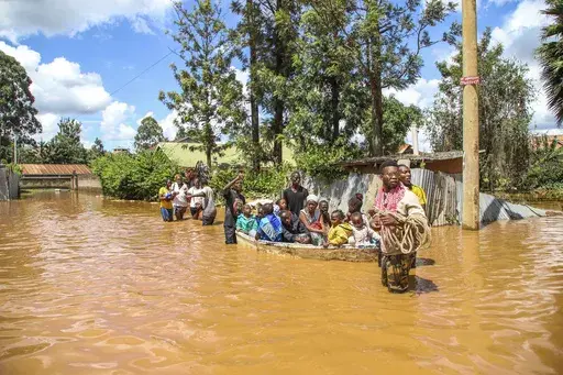 A family uses a boat after fleeing floodwaters that wreaked havoc in the Githurai area of Nairobi, Kenya, April 24, 2024. Extreme weather events have hit parts of Africa relentlessly in the last three years, with tropical storms, floods and drought causing crises of hunger and displacement. They leave another deadly threat behind them: some of the continent's worst outbreaks of cholera. In southern and East Africa, more than 6,000 people have died and nearly 350,000 cases have been reported sinc