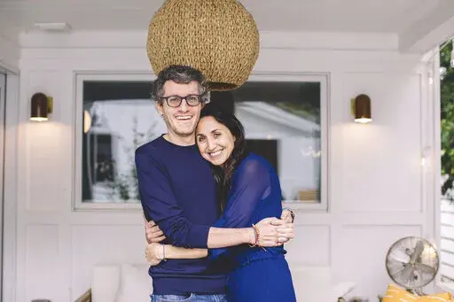 This photo provided by ALS patient Brian Wallach shows him and his wife, Sandra Abrevaya, at their home in Chicago on May 2021. Wallach, who formed I AM ALS with Abrevaya after being diagnosed with ALS in 2017, spent years working on legislation with congressional staffers, researchers and patients which passed the House last December in a landslide 423-3 vote. (Julie Dietz via AP)