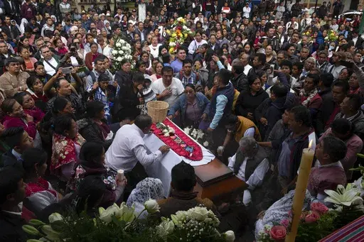 People gather around the coffin of slain Catholic priest and activist Marcelo Pérez during a mass at the main plaza in San Andrés Larráinzar, Chiapas state, Mexico, Monday, Oct. 21, 2024. (AP Photo/Isabel Mateos)