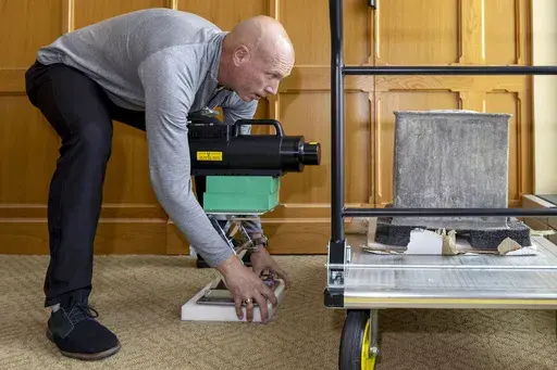 In this photo provided by the U.S. Military Academy at West Point, Kenneth Allen, professor of nuclear engineering, conducts an X-ray on a time capsule, Friday, June 9, 2023. The long-forgotten time capsule, a small lead box measuring about a cubic foot, was discovered in May 2023, during restoration to a monument honoring Revolutionary War hero Thaddeus Kosciuszko on the grounds of West Point, in New York. The box will be opened during a livestreamed event, Monday, Aug. 28. (Christopher Hennen/