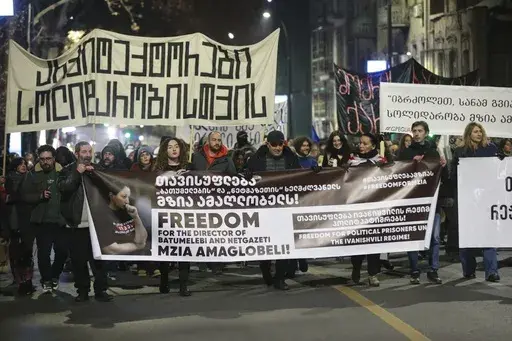 Protesters hold banners calling for the release of jailed journalist Mzia Amaghlobeli as they march through the streets in Tbilisi, Georgia, on Wednesday, Jan. 29, 2025. (AP Photo/Zurab Tsertsvadze)